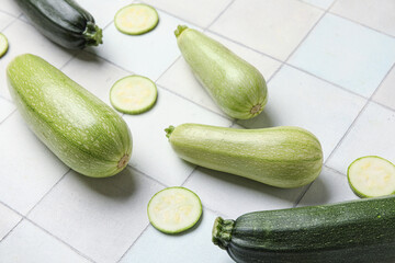Fresh zucchini on white tile background