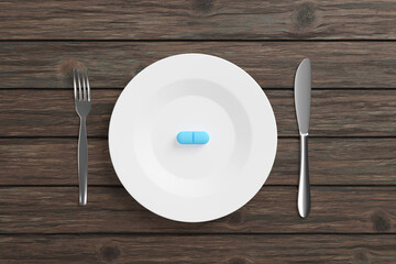 Blue pill on a white dining plate with knife and fork on each side on a wooden table. Illustration of the concept of futuristic superfood and meal in a pill