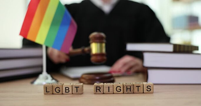 Judge gavel symbol of law and justice with lgbt flag in rainbow colors. LGBT rights and law