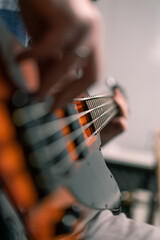 Fototapeta premium rock performer with electric guitar in recording studio recording playing own track creating song musical instrument strings close-up