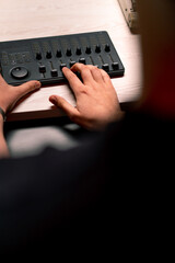 professional recording studio sound engineer with finger adjusts volume level on mixing console...