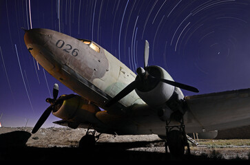 Abandon military transport aircraft and startrails in the background  in the south of Israel 