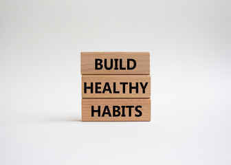 Healthy habits symbol. Concept word Build Healthy habits on wooden blocks. Beautiful white background. Healthy lifestyle and Healthy habits concept. Copy space