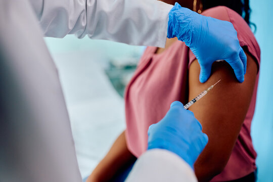 Close Up Of Black Woman Receiving Vaccine At Doctor's Office.