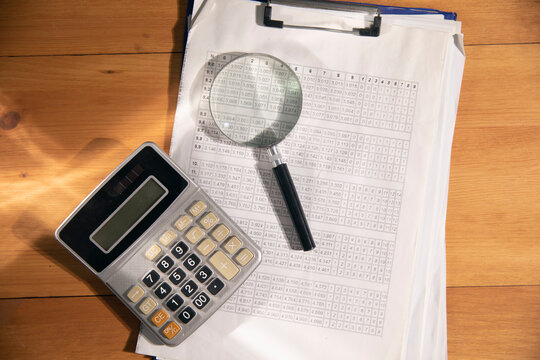 file and calkulator on the wooden table.