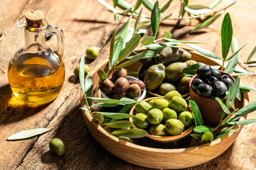 Olive oil and olive berries on a wooden background. place for text