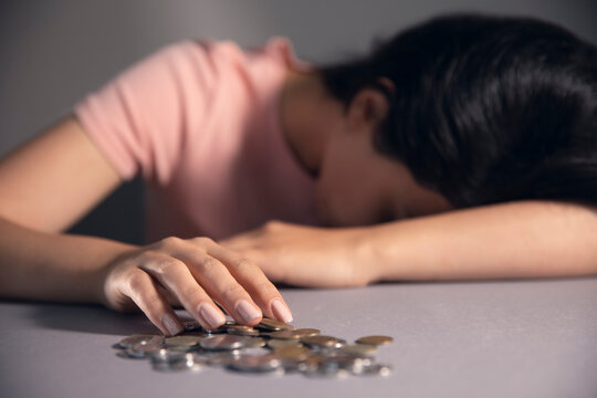 women holding a coins and press calkulator