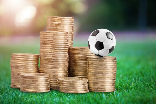 football ball and gold coins, online betting concept