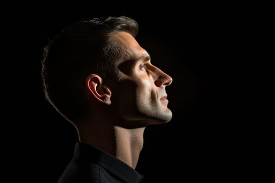 Portrait Of A Young  Man In Profile On A Black Background