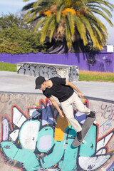 Young man on skate ramp at outdoor skatepark. Montevideo.