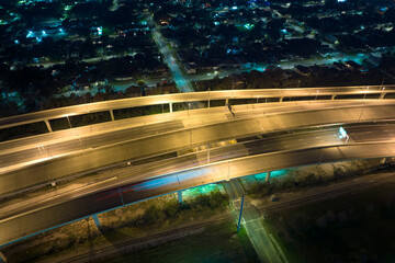 Aerial view of american freeway intersection at night with fast driving cars and trucks in Tampa,...