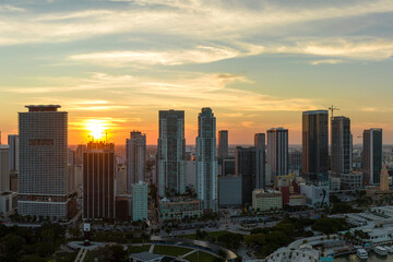Obraz premium Aerial view of downtown office district of Miami Brickell in Florida, USA at sunset. High commercial and residential skyscraper buildings in modern american megapolis