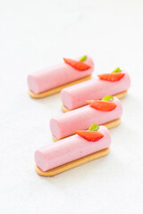 Strawberry cream cake, dessert bar on cookies. Decorated with fresh strawberry slice. White background