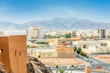 Hail city downtown and walls of Arabian Aarif fortress standing on the hill, Hail, Saudi Arabia