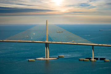 Obraz premium Aerial view of Sunshine Skyway Bridge over Tampa Bay in Florida with moving traffic. Concept of transportation infrastructure