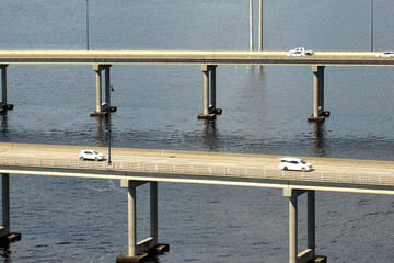 Barron Collier Bridge and Gilchrist Bridge in Florida with moving traffic. Transportation...