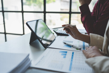 Business team meeting to discuss and analyze statistical data presented in the form of digital graphs and charts. New business ideas in the online world.