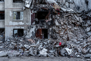 Destroyed residential building wall after russian missle rocket attack during war in Ukraine. House...