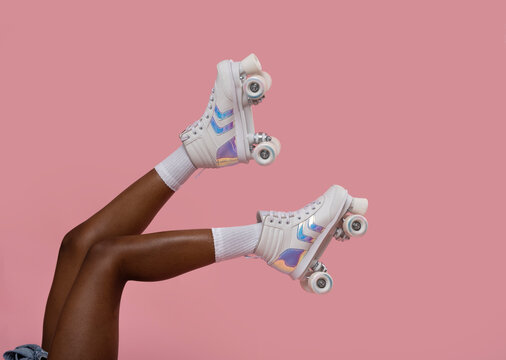Retro roller skates on female legs.