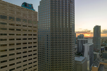 View from above of concrete and glass skyscraper buildings in downtown district of Miami Brickell in Florida, USA at sunset. American megapolis with business financial district at nightfall