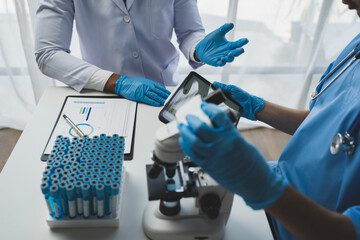 medical research laboratory Team of scientists or doctors using digital tablets analyzing advanced...