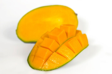 Sliced fresh juicy mango layed down on white, yellow organic exotic healthy fruit