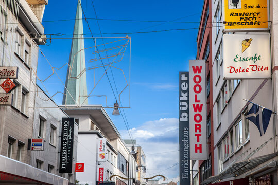 DORTMUND, GERMANY - NOVEMBER 5, 2022: Selective blur on a signs of boutiques in Westenhellweg street with shops & stores. Westenhellweg is a shopping street, high street of Dortmund altstadt, Old Town