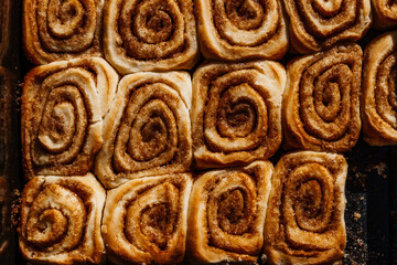 Tasty cinnamon sour dough rolls with sugar. Close up of sweet homemade pastry. 