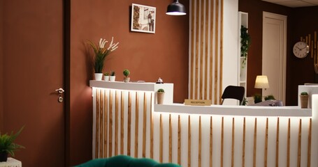 Empty stylish modern hotel lounge interior with cozy furniture and warm fireplace ready to welcome...