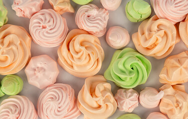 A background of colored meringues laid out next to each other.