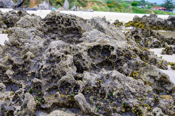 View on Playa de Borizo in Celorio, Green coast of Asturias, North Spain with sandy beaches, cliffs, hidden caves, green fields and mountains.