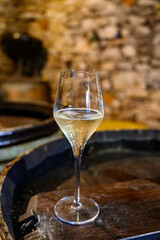 Tasting of grand cru sparkling white wine with bubbles champagne by old champagne caves in grand cru wine producer small village Cramant, Champagne, France