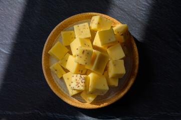 Cheese collection, matured yellow cow cheese with mustard seeds from Belgium