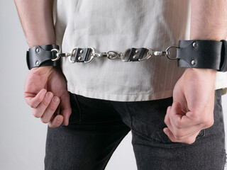 a white man with a short haircut and an athletic build in a shirt and a leather belt bdsm image on...