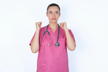 young caucasian doctor woman wearing pink uniform over white background champion having success being glad to achieve his goals. Victory and triumph concept.