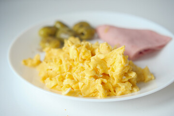 morning breakfast with Scrambled eggs on a bread on white plate 
