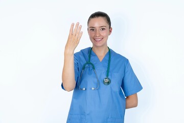 young caucasian doctor woman wearing medical uniform over white background smiling and looking friendly, showing number four or fourth with hand forward, counting down