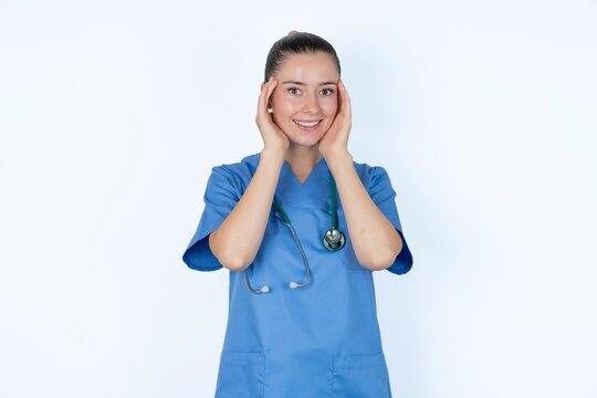 young caucasian doctor woman wearing medical uniform over white background Pleasant looking cheerful, Happy reaction