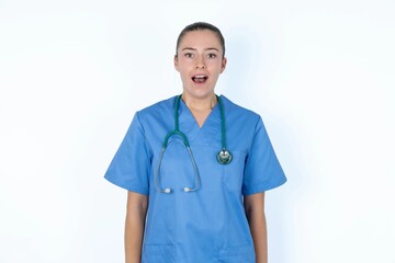 young caucasian doctor woman wearing medical uniform over white background yawns with opened mouth stands. Daily morning routine