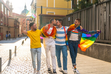 Couples of men having fun and kissing at the demonstration with the rainbow flags, gay pride party...