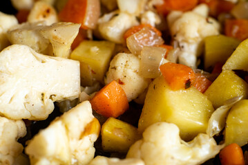 vegetable stew of carrots, cauliflower, onions, potatoes close-up. Vegetarian food, vegan pie filling recipe.