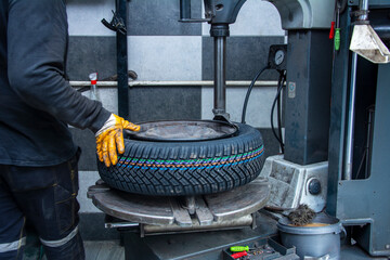 Serviceman attaches new wheel to rim