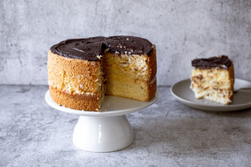 Chocolate Boston cream pie on a gray background. Close-up