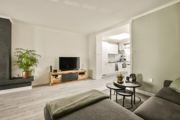 a living room with couches and a flat screen tv in the wall is on the right side of the room