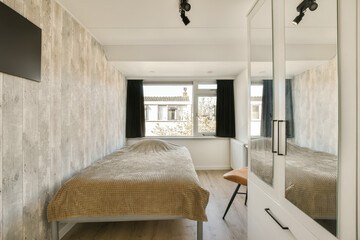 a bedroom with two beds and a large mirror on the wall behind it is a tv mounted above the bed