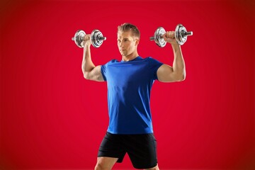 Young sexy sporty strong sportsman hold dumbbells
