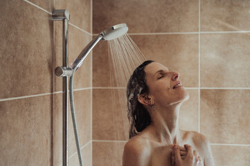 Young woman enjyoing a hot shower after a long day
