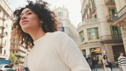 Young woman is calling a taxi. Girl stands next to the road raises her hand waiting for a taxi