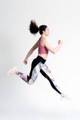 Side portrait of athletic woman in black sportswear running marathon, jogging, speed race
