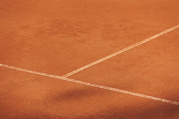 tennis court made of red clay soil with markings for game or competition. sports and recreation, professional performance champions in lawn tennis with rackets and balls. training of athletes outdoor